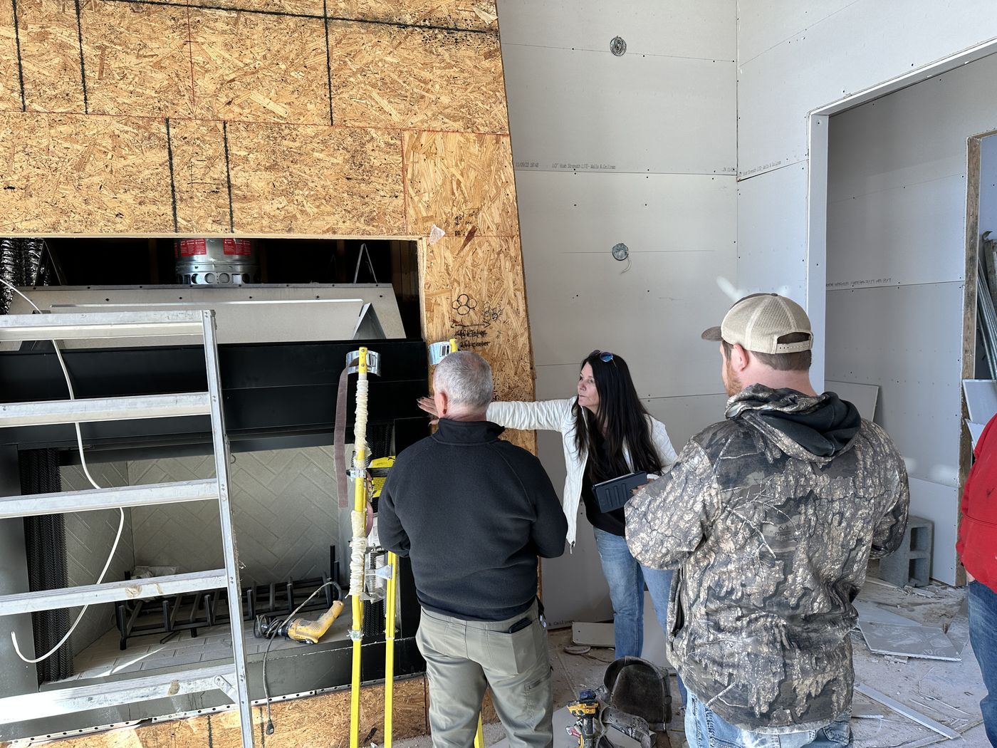 Installing fireplace insert during finishing stage